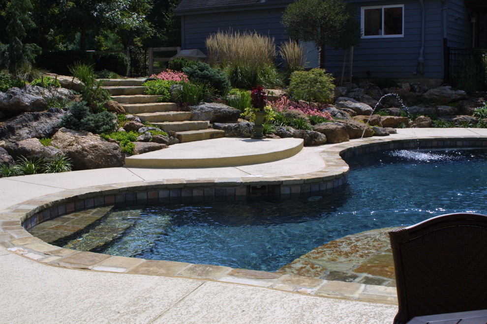 Inspiration for a mid-sized timeless backyard stone and custom-shaped lap pool fountain remodel in St Louis