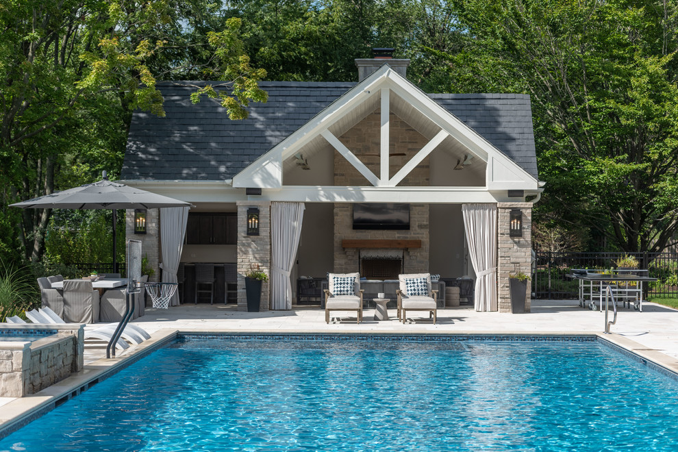 Diseño de casa de la piscina y piscina clásica extra grande rectangular en patio trasero con adoquines de piedra natural