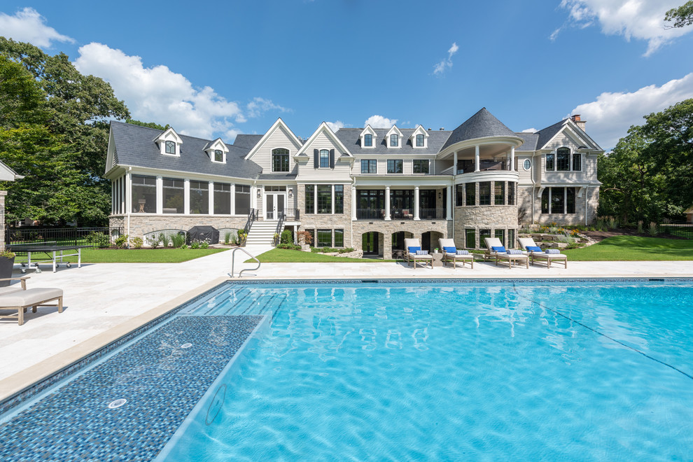 Foto de casa de la piscina y piscina clásica extra grande rectangular en patio trasero con adoquines de piedra natural