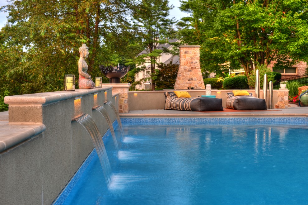 Inspiration for a large modern back rectangular lengths swimming pool in Philadelphia with concrete slabs.