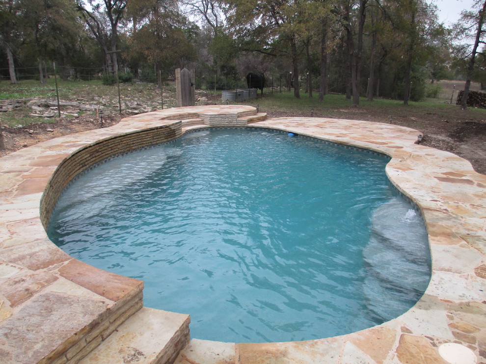 Idée de décoration pour une piscine naturelle et arrière tradition de taille moyenne et sur mesure avec des pavés en pierre naturelle.