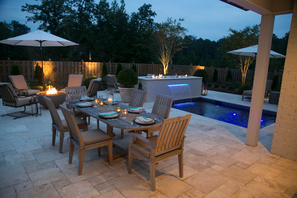 Example of a small backyard stone and rectangular pool design in Birmingham
