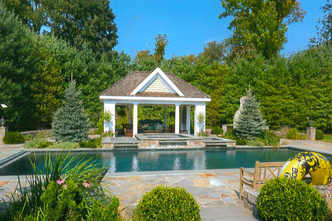 Diseño de casa de la piscina y piscina alargada clásica de tamaño medio rectangular en patio trasero con adoquines de piedra natural