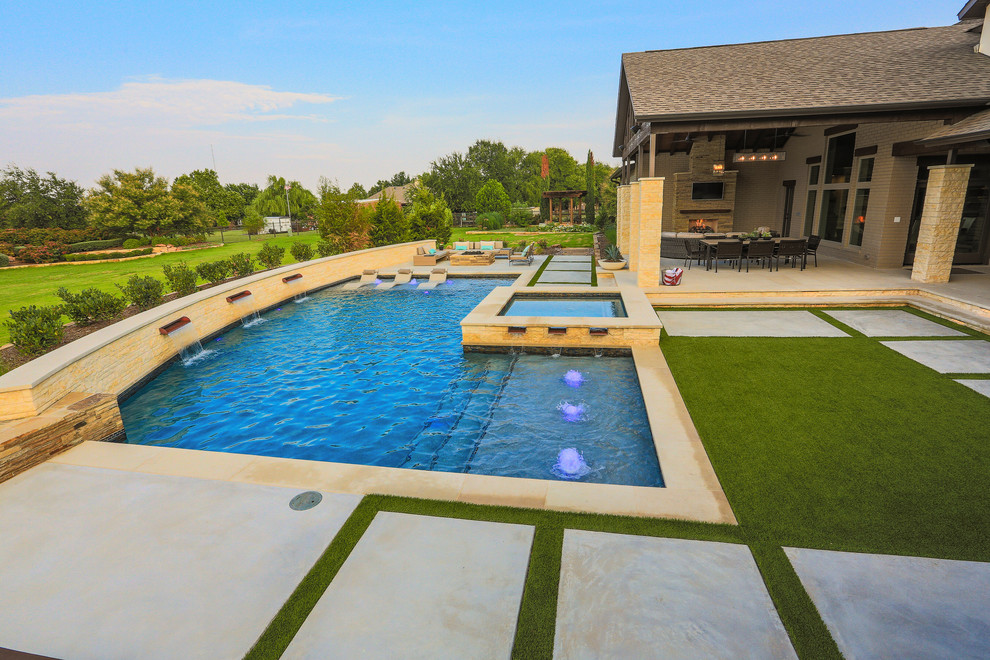 Свежая идея для дизайна: большой угловой бассейн на заднем дворе в современном стиле с покрытием из бетонных плит - отличное фото интерьера