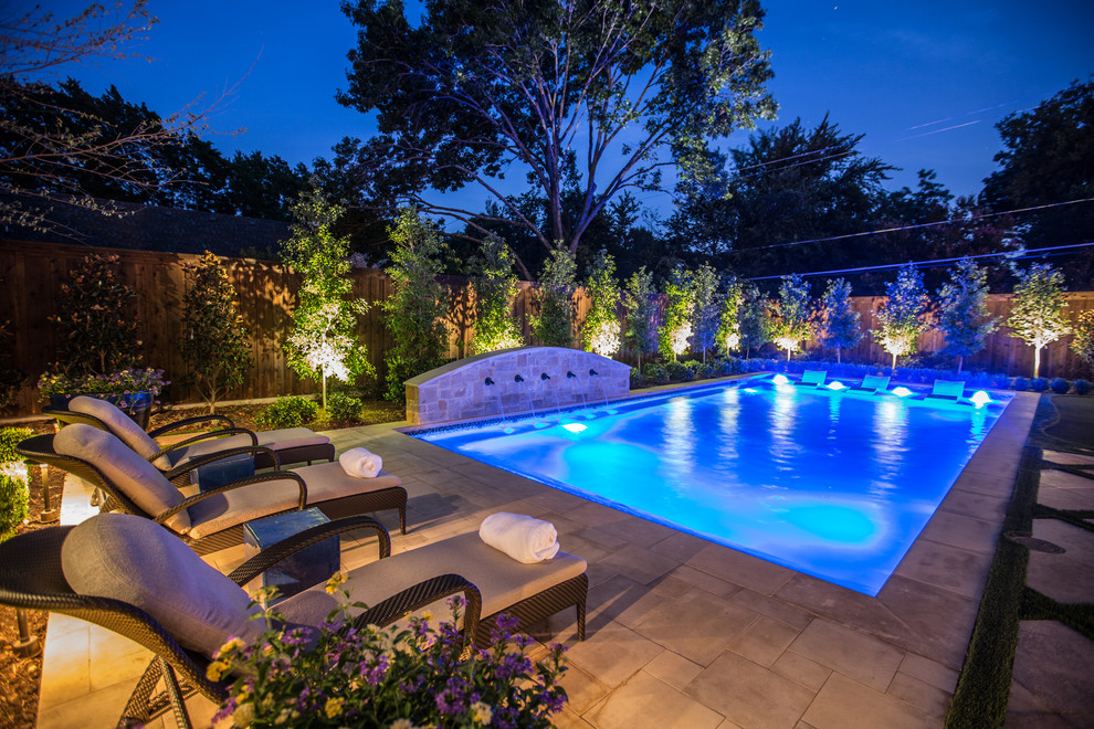 Mid-sized tuscan backyard stone and rectangular lap pool fountain photo in Dallas