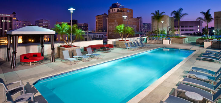 Photo of a large contemporary roof rectangular lengths swimming pool in Los Angeles with concrete slabs.