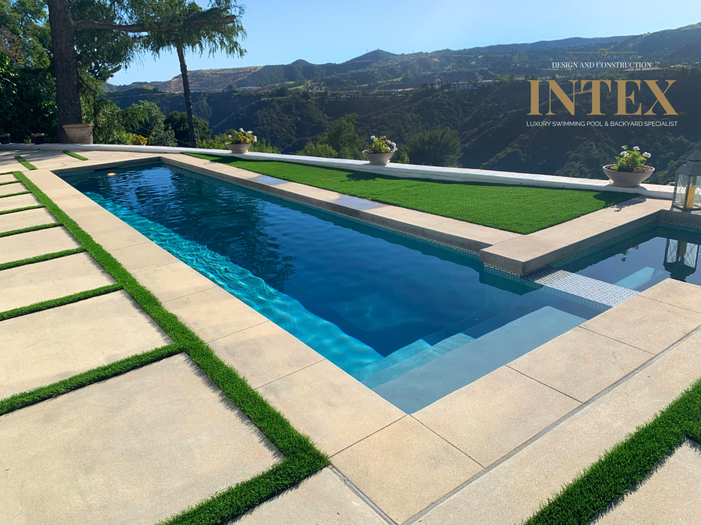 Inspiration for a large backyard custom-shaped lap pool remodel in Los Angeles