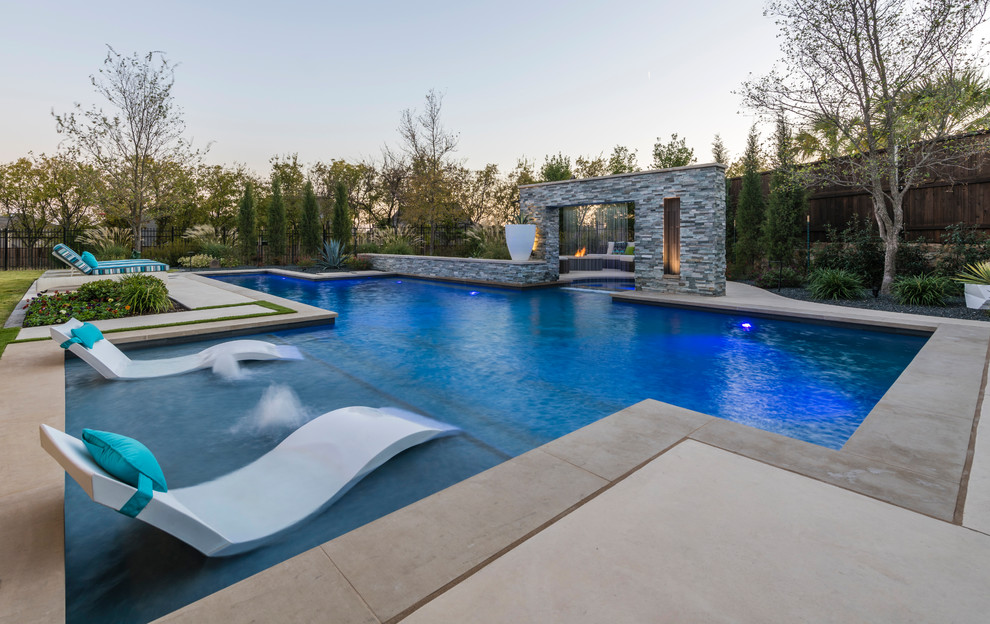 Example of a large transitional backyard concrete and custom-shaped lap pool fountain design in Dallas