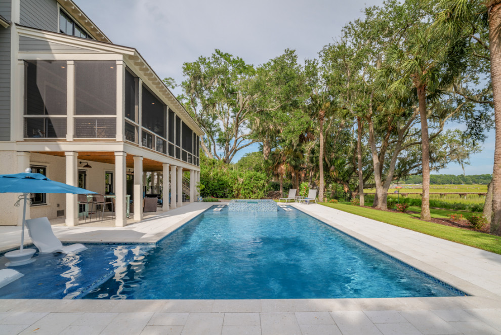 Idee per una piscina monocorsia costiera a "L" di medie dimensioni e dietro casa con pavimentazioni in pietra naturale