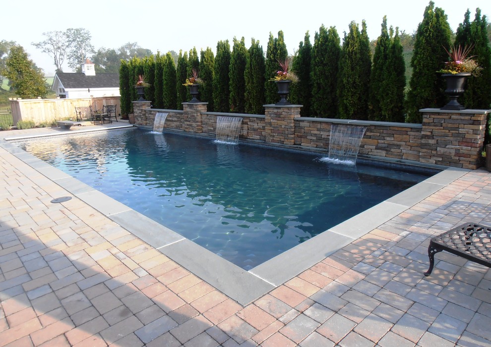 Идея дизайна: естественный, прямоугольный бассейн на заднем дворе в классическом стиле с фонтаном и мощением клинкерной брусчаткой
