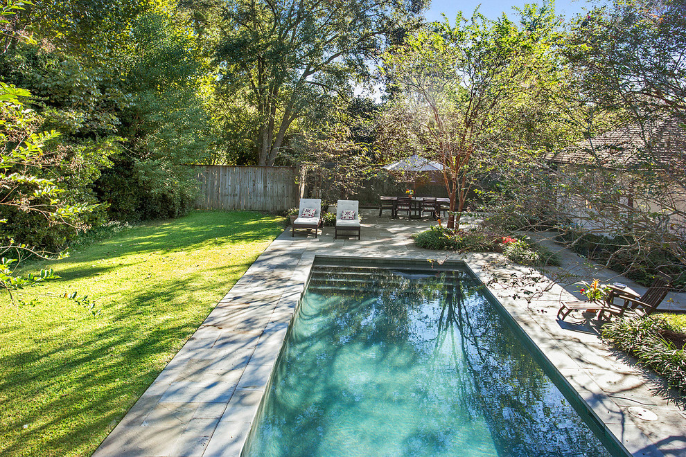 Inspiration for a mid-sized timeless backyard stone and rectangular pool remodel in New Orleans