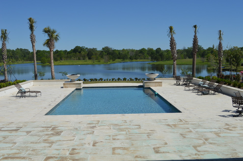 Photo of a large mediterranean back rectangular lengths swimming pool in Jackson with a water feature and natural stone paving.
