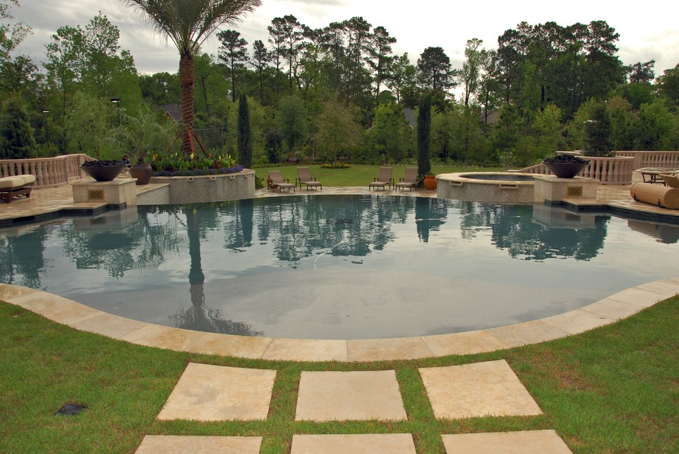 Hot tub - mediterranean backyard tile infinity hot tub idea in Houston