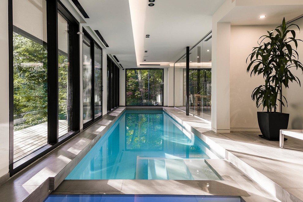Contemporary indoor rectangular lengths swimming pool in Toronto.