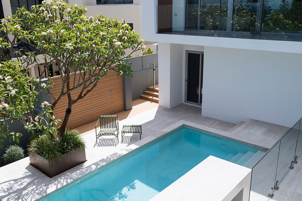 Inspiration for a mid-sized modern backyard tile and rectangular infinity pool remodel in Perth