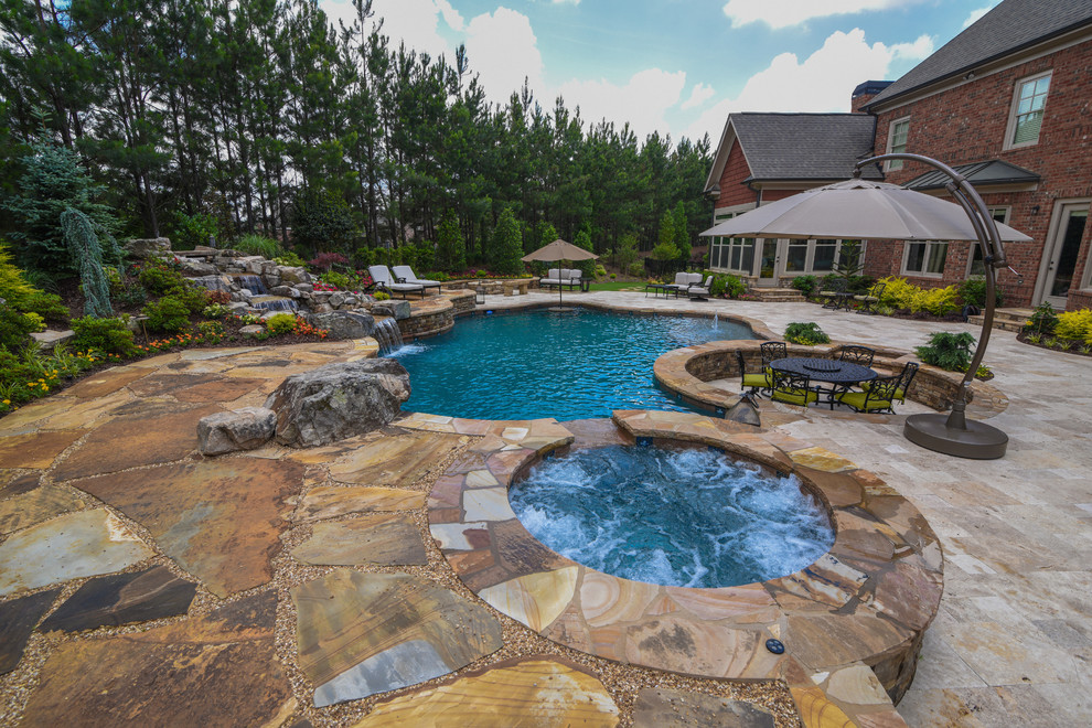 Expansive world-inspired back natural swimming pool in Atlanta.