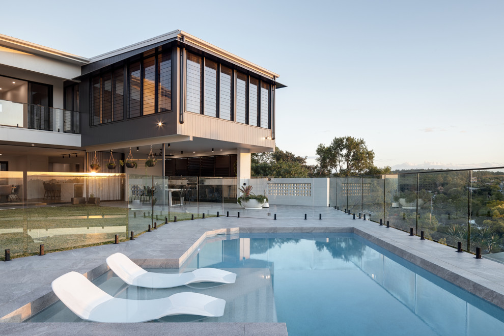 Large trendy tile and custom-shaped pool photo in Brisbane