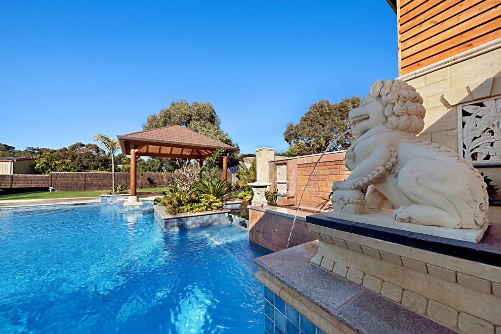 Pool fountain - huge mediterranean backyard custom-shaped infinity pool fountain idea in Perth with decking