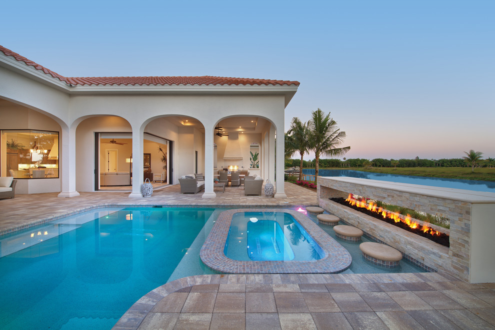 Photo of a mediterranean back l-shaped lengths hot tub in Miami with tiled flooring.