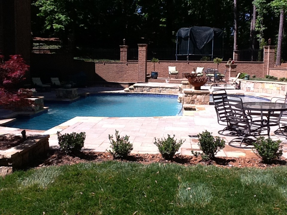 Design ideas for a large modern back rectangular hot tub in Atlanta with stamped concrete.