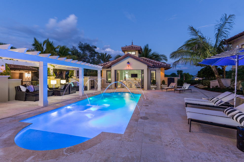 Photo of a large traditional front custom shaped swimming pool in Tampa with a pool house.