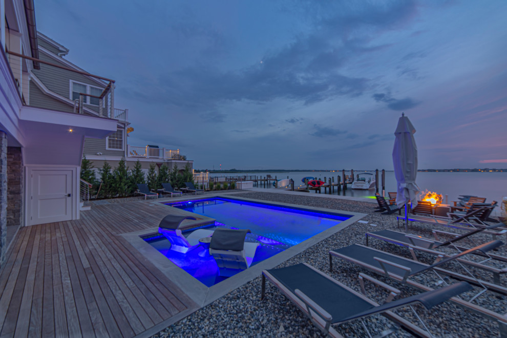 Inspiration for a medium sized modern back l-shaped swimming pool in New York with decking.