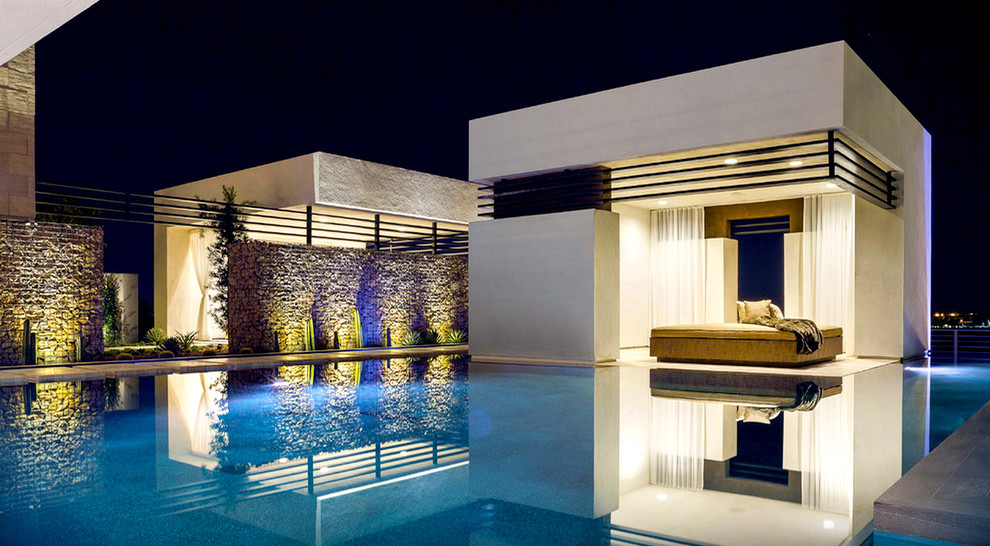 Inspiration for a contemporary back l-shaped swimming pool in Los Angeles with a pool house.
