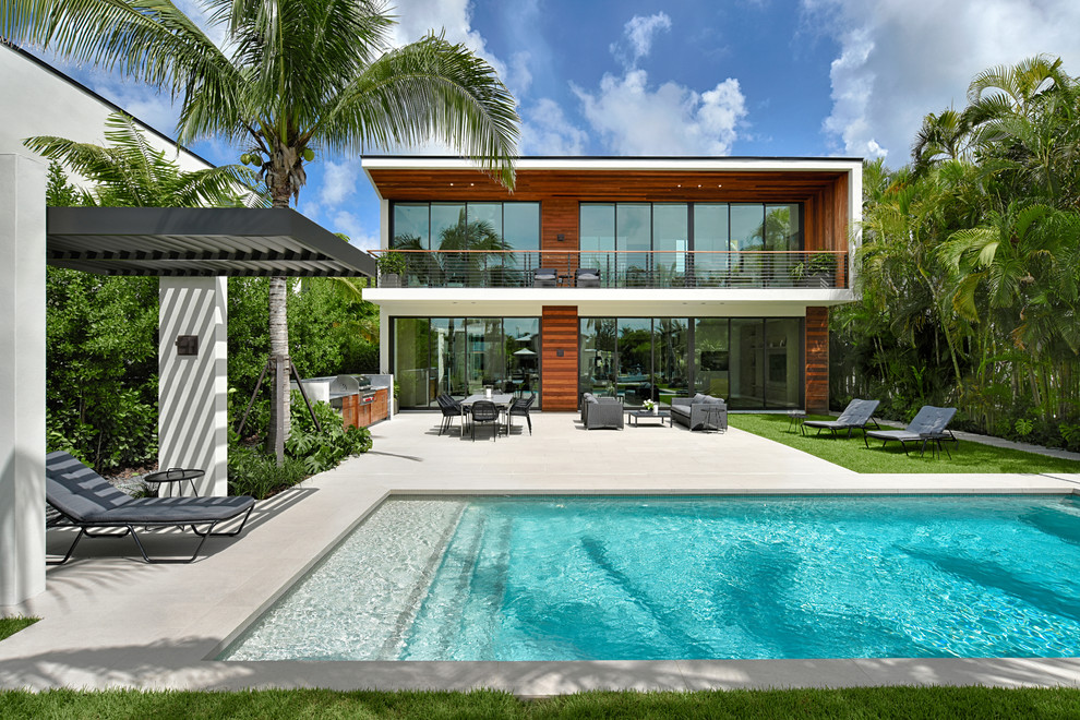Pool - contemporary backyard tile and rectangular lap pool idea in Miami