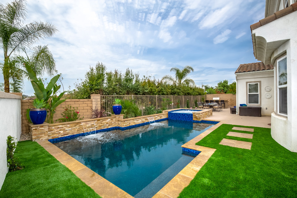 Exempel på en liten klassisk anpassad pool på baksidan av huset, med naturstensplattor