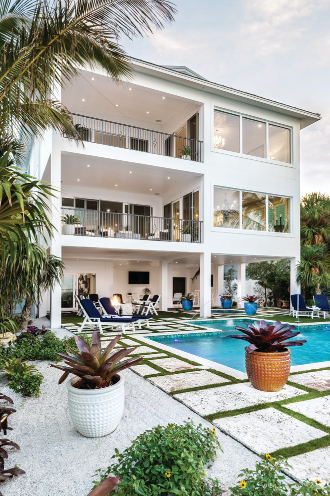 Inspiration for a large classic back rectangular lengths swimming pool in Miami with a water feature.