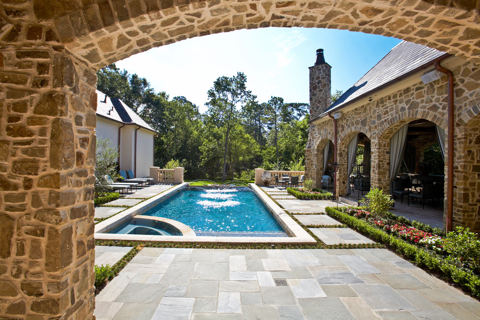 Pool - large mediterranean courtyard tile and rectangular lap pool idea in Houston
