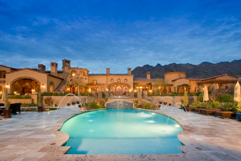 Стильный дизайн: огромный бассейн произвольной формы на заднем дворе в средиземноморском стиле с фонтаном и мощением тротуарной плиткой - последний тренд