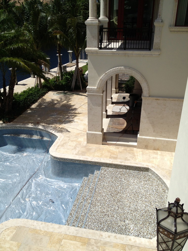 Foto di una piscina mediterranea personalizzata dietro casa con piastrelle