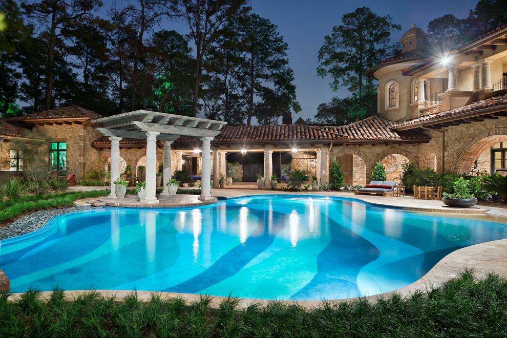 Inspiration for an expansive mediterranean back custom shaped swimming pool in Houston.