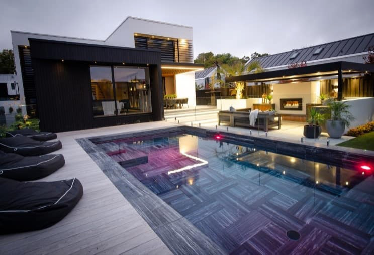 Esempio di una grande piscina monocorsia minimalista rettangolare davanti casa con paesaggistica bordo piscina e piastrelle