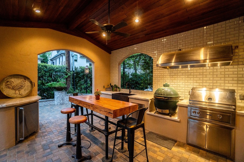 Inspiration for a large mediterranean back patio in Houston with concrete paving.