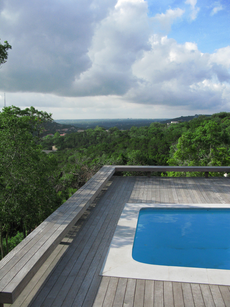 Photo of a modern roof swimming pool in Austin with decking.
