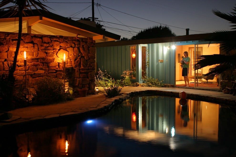 Mid-sized 1960s backyard stone and custom-shaped natural pool house photo in Los Angeles