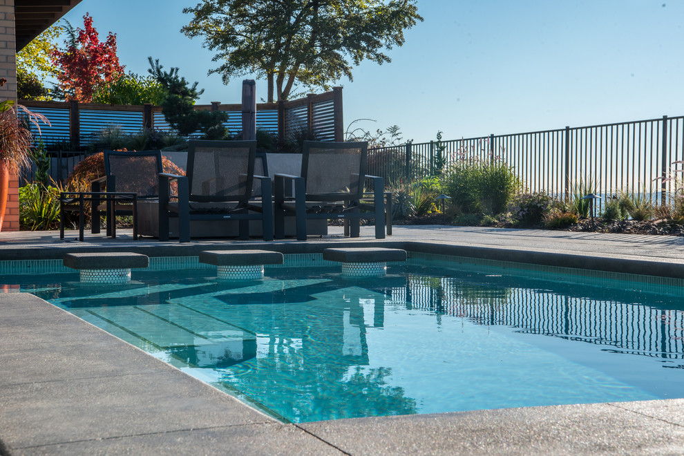 Mid-sized trendy backyard rectangular pool photo in Seattle