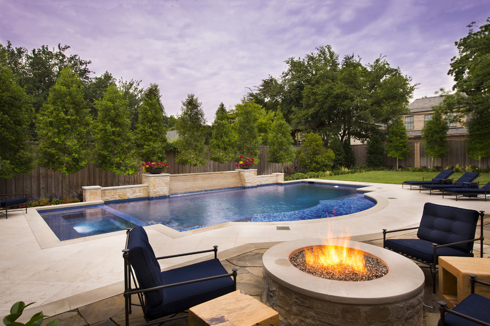 Design ideas for a mediterranean custom shaped swimming pool in Dallas with stamped concrete.