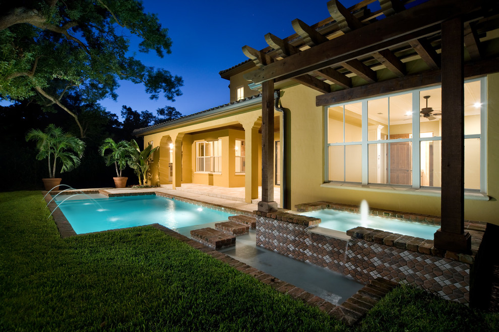 Design ideas for a mediterranean swimming pool in Orlando with brick paving.