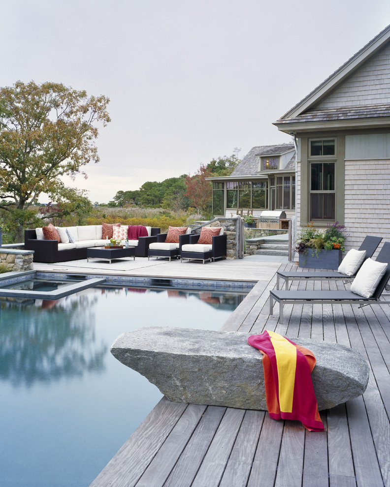 Inspiration for a transitional rectangular pool remodel in Boston with decking