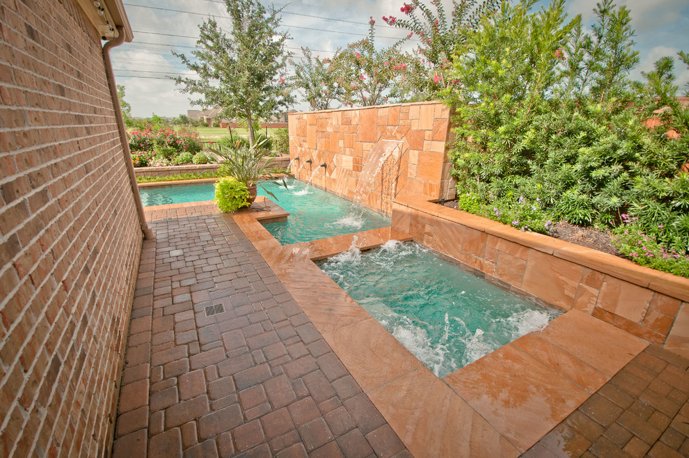 Inspiration for a medium sized traditional side l-shaped hot tub in Houston with natural stone paving.