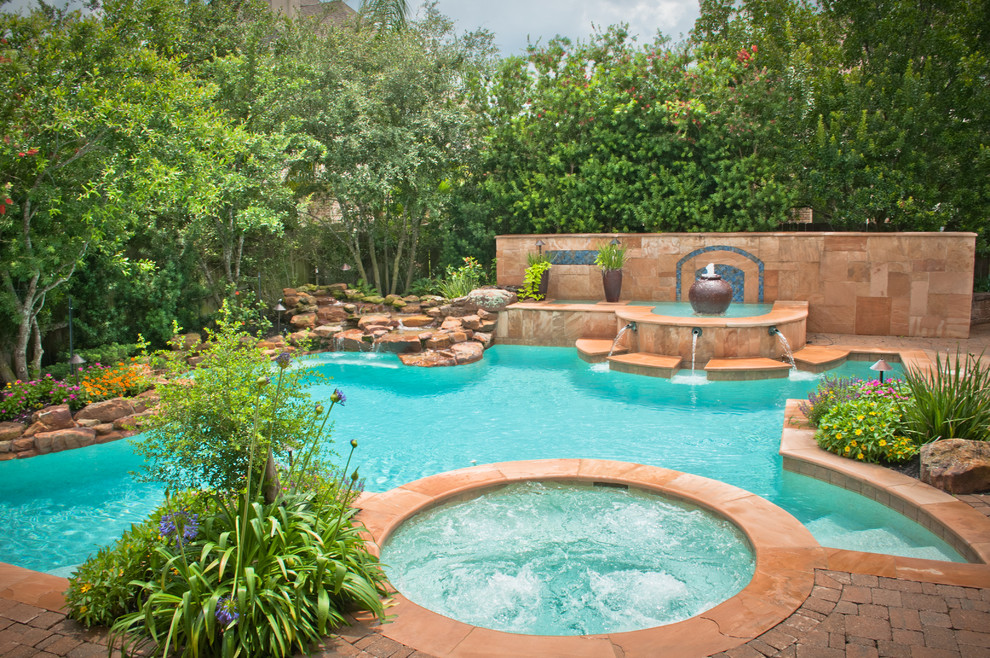 Inspiration for a large timeless backyard brick and custom-shaped pool fountain remodel in Houston