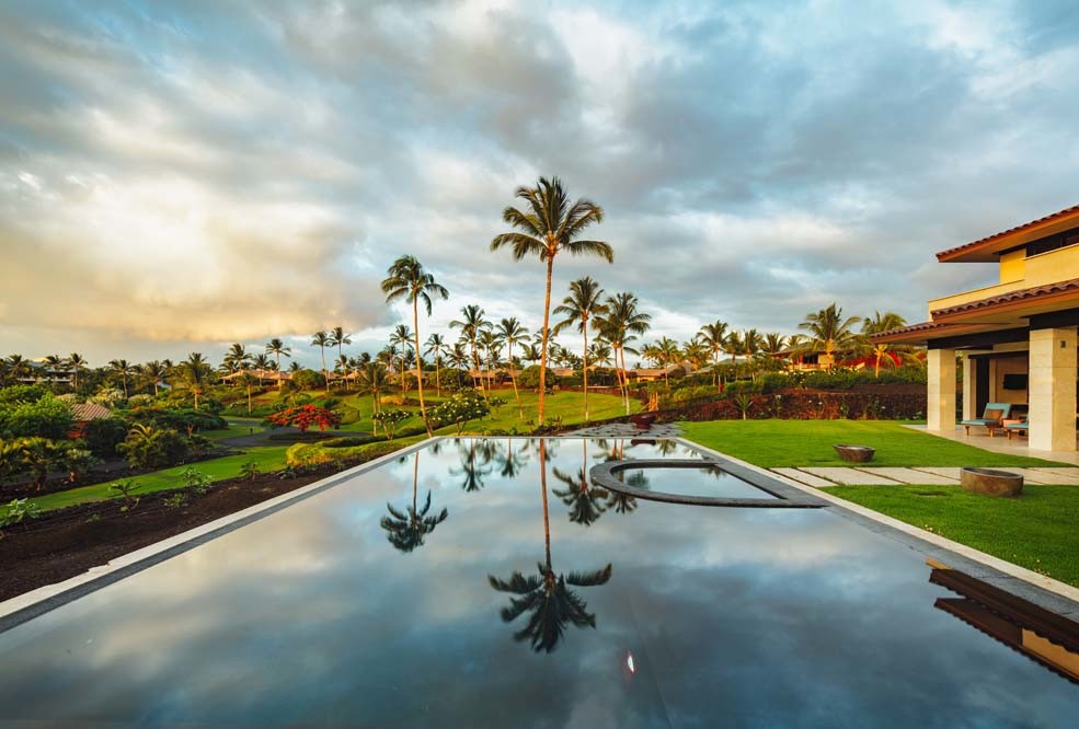 Pool - large contemporary backyard rectangular infinity pool idea in Hawaii