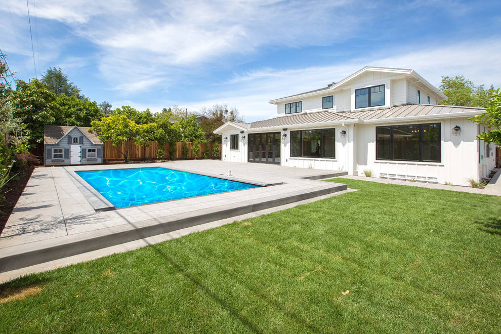 Inspiration for a large farmhouse backyard concrete paver and rectangular lap pool remodel in San Francisco