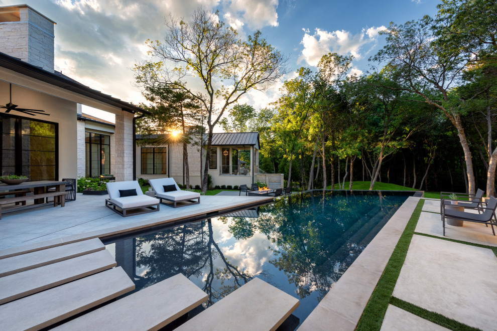 Inspiration for a mid-sized farmhouse backyard concrete paver and custom-shaped infinity pool landscaping remodel in Dallas