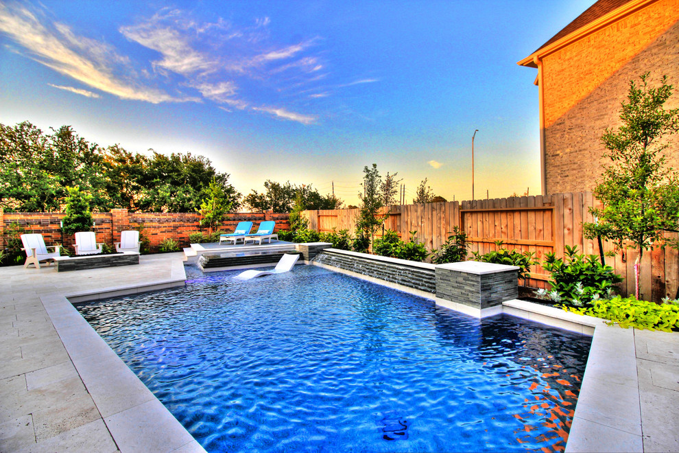 Photo of a medium sized modern back rectangular swimming pool in Houston with natural stone paving.