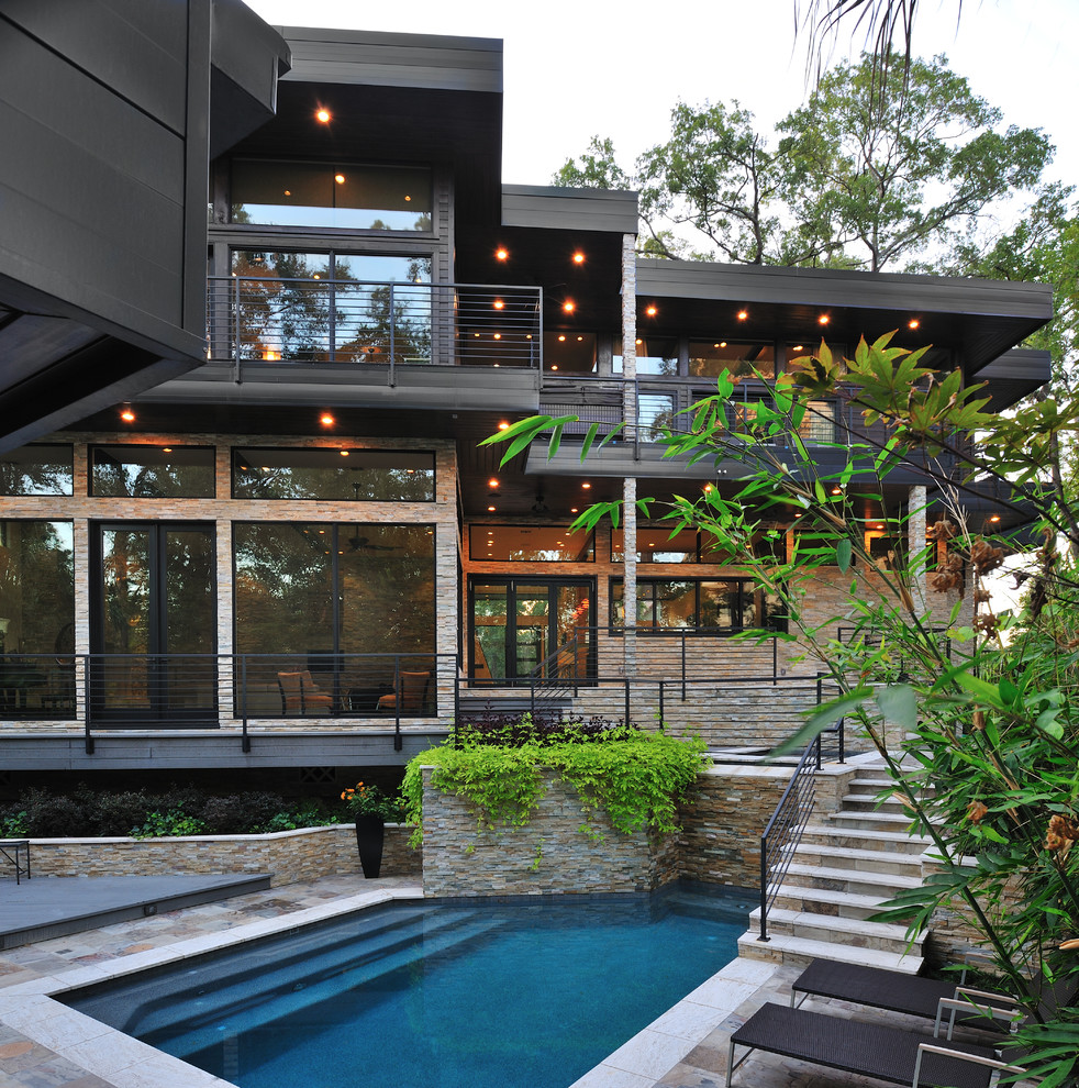 This is an example of a contemporary custom shaped swimming pool in Houston.