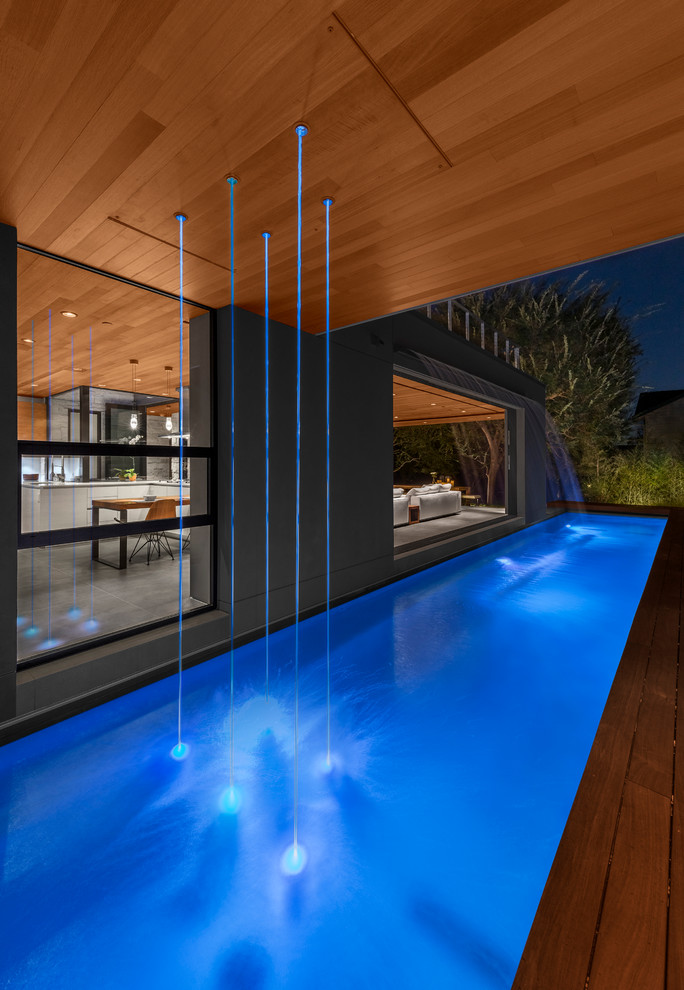 Immagine di una piscina monocorsia minimal con fontane